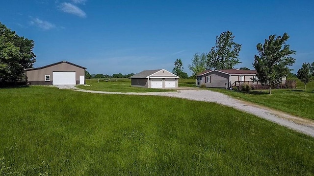 38686 Jingo Rd, Lacygne, KS 66040 - view of grassy yard featuring a garage and an outdoor structure