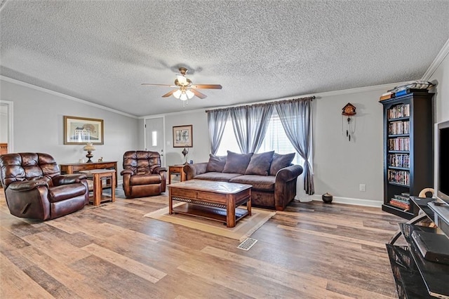 38686 Jingo Rd, Lacygne, KS 66040 - living area with ornamental molding, a ceiling fan, wood finished floors, a textured ceiling, and baseboards