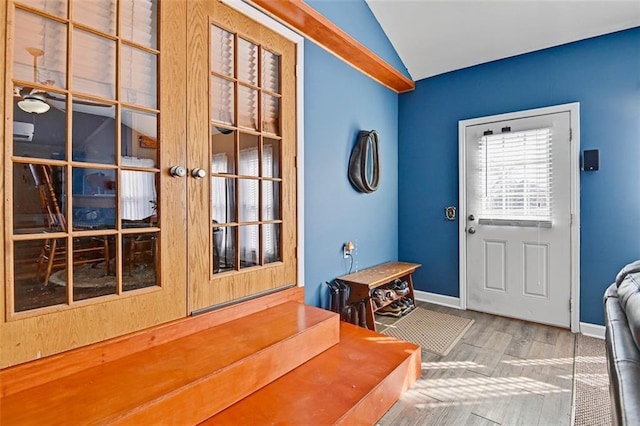 38686 Jingo Rd, Lacygne, KS 66040 - foyer entrance featuring lofted ceiling, wood finished floors, and baseboards