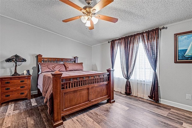 38686 Jingo Rd, Lacygne, KS 66040 - bedroom featuring a textured ceiling, wood finished floors, ornamental molding, a ceiling fan, and baseboards