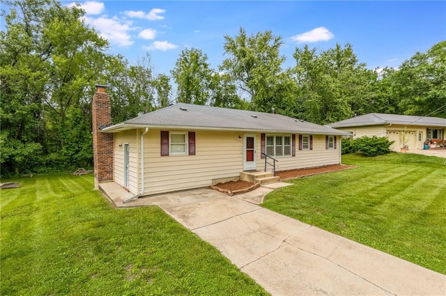 1221 Sunset St, Chillicothe, MO 64601 - ranch-style home featuring a chimney, a front lawn, and driveway