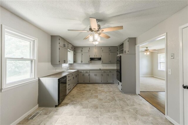 1221 Sunset St, Chillicothe, MO 64601 - kitchen featuring black appliances, ceiling fan, gray cabinets, under cabinet range hood, and a sink