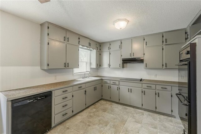 1221 Sunset St, Chillicothe, MO 64601 - kitchen featuring black appliances, a sink, a textured ceiling, and under cabinet range hood