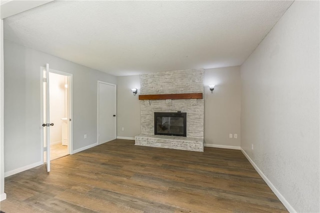 1221 Sunset St, Chillicothe, MO 64601 - unfurnished living room featuring wood finished floors, a large fireplace, and baseboards