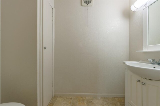 1221 Sunset St, Chillicothe, MO 64601 - bathroom with vanity, baseboards, and toilet
