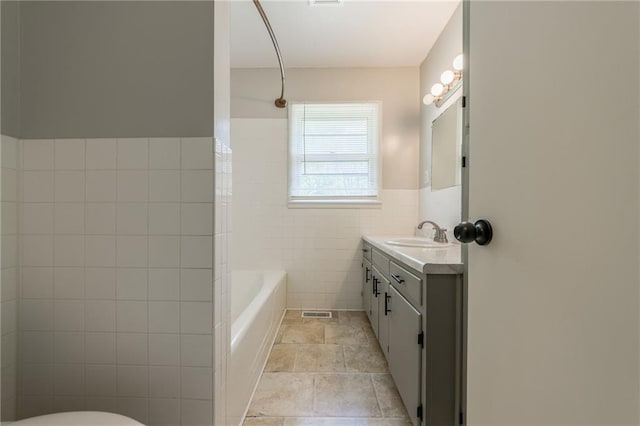 1221 Sunset St, Chillicothe, MO 64601 - full bath featuring tile walls, vanity, toilet, and wainscoting