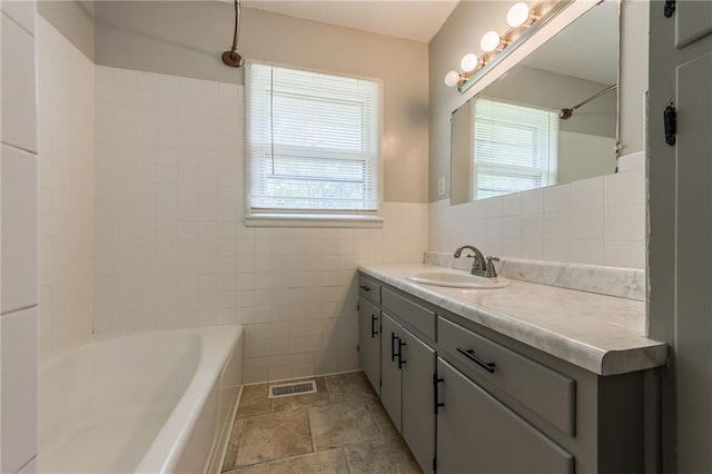 1221 Sunset St, Chillicothe, MO 64601 - full bath with plenty of natural light, tile walls, vanity, and tub / shower combination