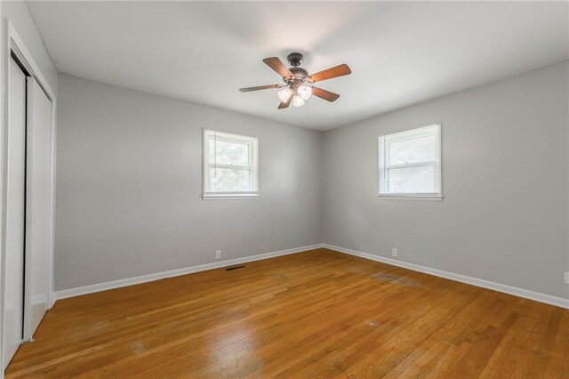 1221 Sunset St, Chillicothe, MO 64601 - unfurnished bedroom featuring a closet, light wood finished floors, baseboards, and ceiling fan