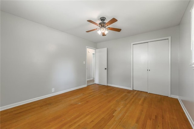 1221 Sunset St, Chillicothe, MO 64601 - unfurnished bedroom featuring baseboards, light wood-style flooring, a ceiling fan, and a closet