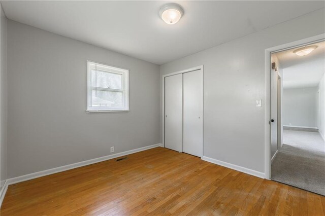 1221 Sunset St, Chillicothe, MO 64601 - unfurnished bedroom featuring light wood-style floors, baseboards, and a closet