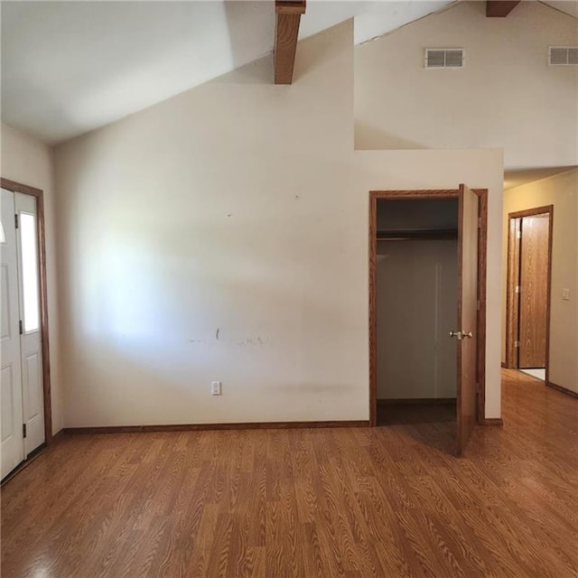 411 Briarwood Dr, Iola, KS 66749 - unfurnished bedroom featuring wood finished floors, vaulted ceiling, baseboards, and a closet