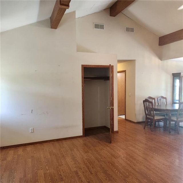 411 Briarwood Dr, Iola, KS 66749 - bedroom featuring beamed ceiling, wood finished floors, high vaulted ceiling, baseboards, and a closet