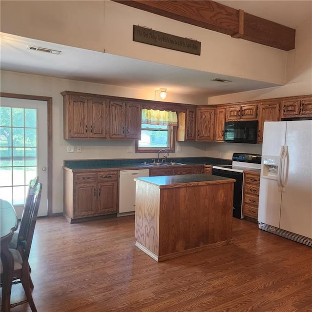 411 Briarwood Dr, Iola, KS 66749 - kitchen featuring white appliances, dark wood-style flooring, a sink, and dark countertops