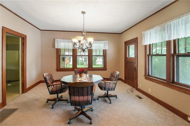 1601 Stevens Ave, Parsons, KS 67357 - dining space with crown molding, light carpet, a chandelier, and baseboards