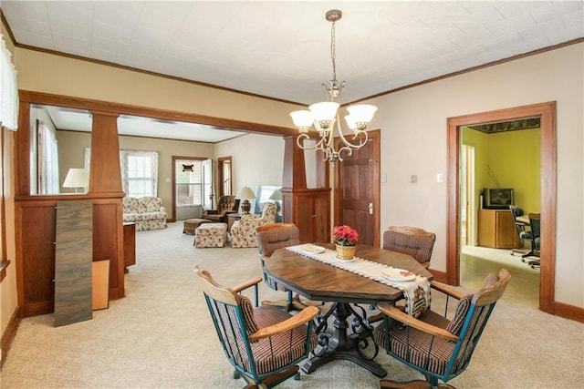 1601 Stevens Ave, Parsons, KS 67357 - dining area with light colored carpet, ornamental molding, a chandelier, and baseboards