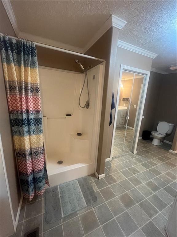 933 1300th St, Iola, KS 66749 - full bathroom with crown molding, a shower stall, tile patterned floors, toilet, and a textured ceiling