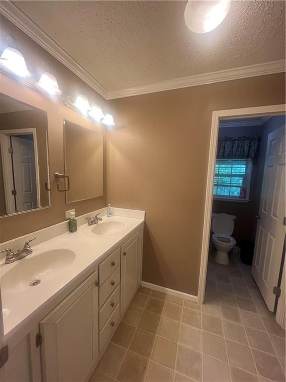 933 1300th St, Iola, KS 66749 - full bathroom with toilet, double vanity, a textured ceiling, crown molding, and tile patterned flooring