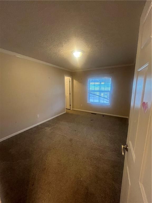 933 1300th St, Iola, KS 66749 - empty room featuring crown molding, a textured ceiling, baseboards, and carpet flooring