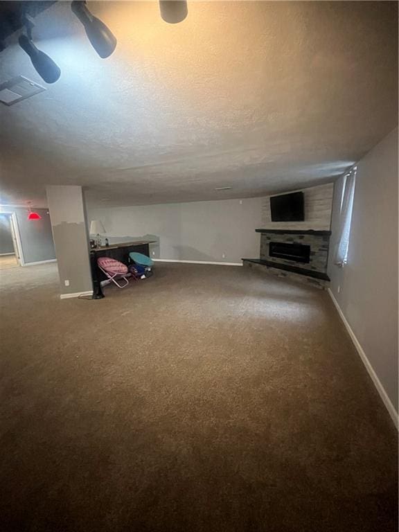 933 1300th St, Iola, KS 66749 - unfurnished living room with carpet, baseboards, and a fireplace with raised hearth