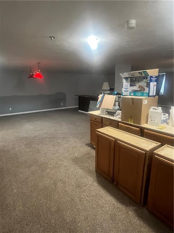 933 1300th St, Iola, KS 66749 - kitchen featuring light carpet and brown cabinetry