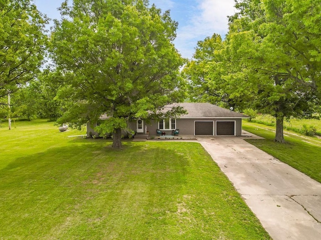 33991 Mission Belleview Rd, Louisburg, KS 66053 - view of front of property featuring an attached garage, a front lawn, concrete driveway, and stucco siding
