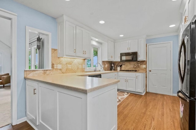33991 Mission Belleview Rd, Louisburg, KS 66053 - kitchen with black appliances, white cabinets, light wood-style floors, and recessed lighting