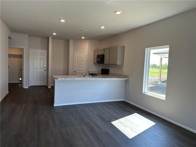 37779 W 207th Ter, Edgerton, KS 66021 - kitchen with black microwave, electric range, dark wood finished floors, gray cabinets, and baseboards