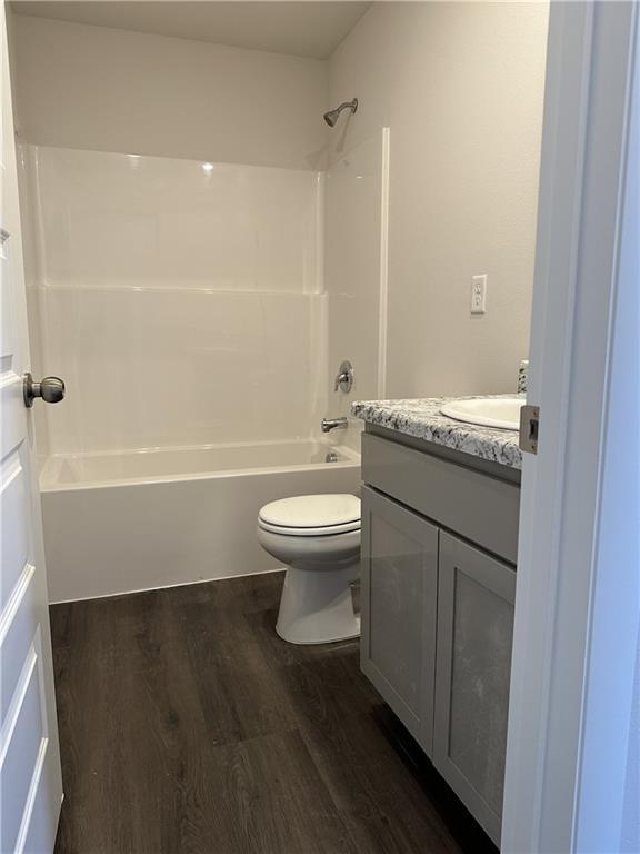 37779 W 207th Ter, Edgerton, KS 66021 - full bath with vanity, wood finished floors, toilet, and shower / bath combination