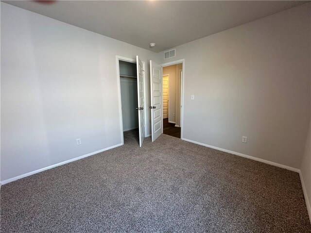 37779 W 207th Ter, Edgerton, KS 66021 - unfurnished bedroom featuring dark colored carpet, baseboards, and a closet