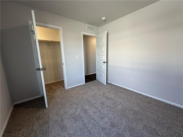 37779 W 207th Ter, Edgerton, KS 66021 - unfurnished bedroom featuring carpet flooring, baseboards, a walk in closet, and a closet