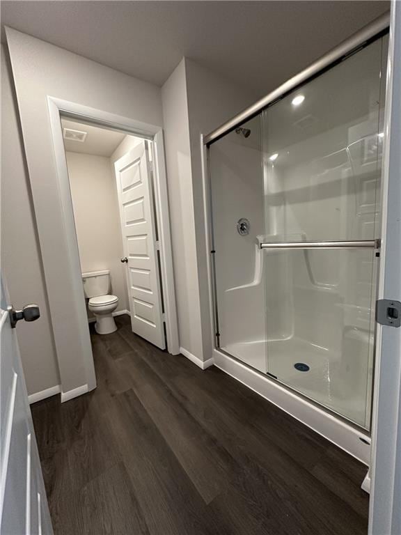 37779 W 207th Ter, Edgerton, KS 66021 - full bath featuring baseboards, wood finished floors, toilet, and a stall shower