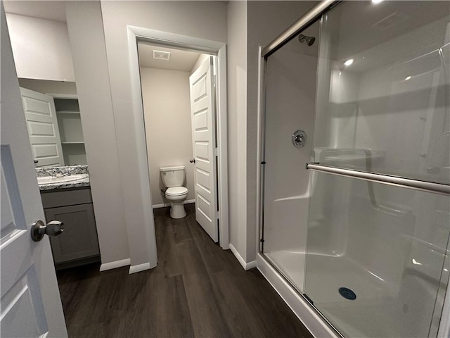 37779 W 207th Ter, Edgerton, KS 66021 - bathroom featuring wood finished floors, baseboards, a stall shower, and toilet