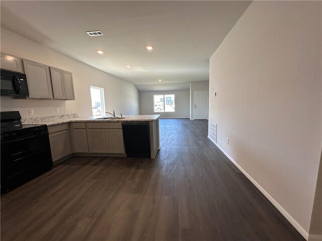 37779 W 207th Ter, Edgerton, KS 66021 - kitchen with black appliances, a peninsula, dark wood-style flooring, baseboards, and open floor plan