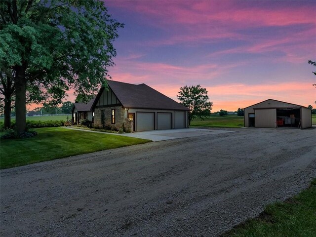 12806 33rd Hwy, Kearney, MO 64060 - view of front facade with dirt driveway, a yard, board and batten siding, stone siding, and an outdoor structure