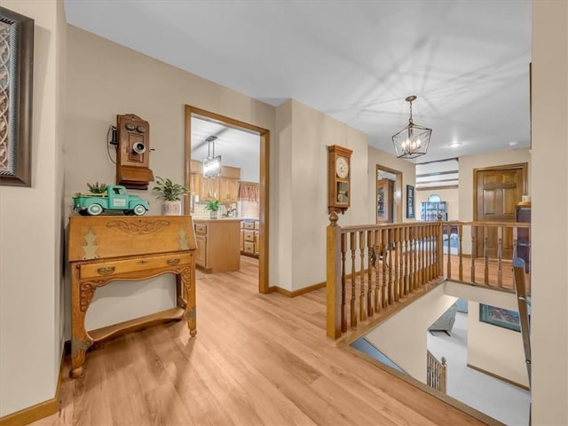12806 33rd Hwy, Kearney, MO 64060 - corridor with an upstairs landing, a chandelier, light wood-type flooring, and baseboards