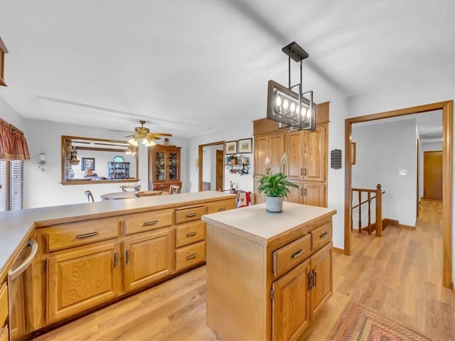 12806 33rd Hwy, Kearney, MO 64060 - kitchen with light countertops, a center island, light wood-type flooring, a ceiling fan, and pendant lighting