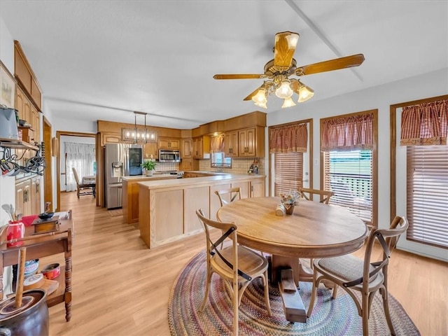12806 33rd Hwy, Kearney, MO 64060 - dining room featuring light wood-style floors, ceiling fan, and a chandelier