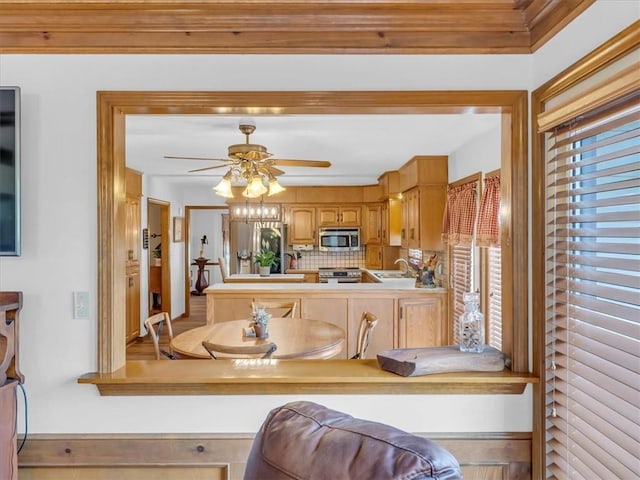 12806 33rd Hwy, Kearney, MO 64060 - kitchen featuring appliances with stainless steel finishes, a sink, a ceiling fan, decorative backsplash, and light countertops