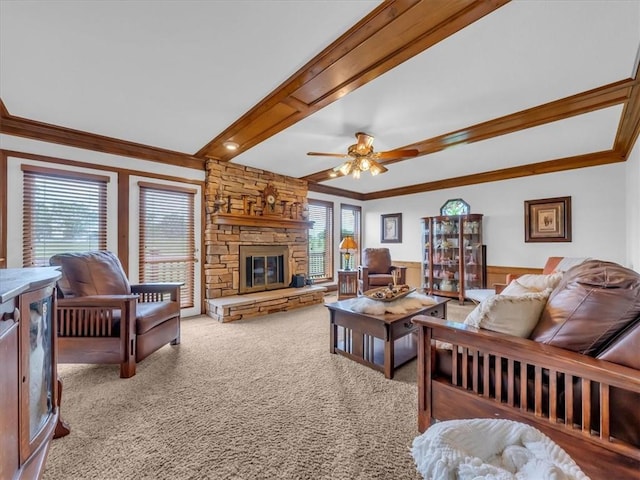 12806 33rd Hwy, Kearney, MO 64060 - carpeted living room featuring ornamental molding, a stone fireplace, ceiling fan, beamed ceiling, and a wainscoted wall