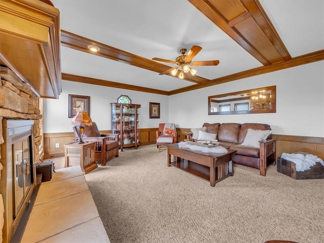 12806 33rd Hwy, Kearney, MO 64060 - living room featuring wainscoting, a fireplace, crown molding, a ceiling fan, and carpet flooring