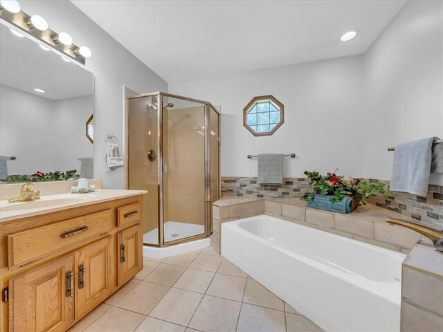 12806 33rd Hwy, Kearney, MO 64060 - full bathroom featuring vanity, a garden tub, a stall shower, and tile patterned flooring