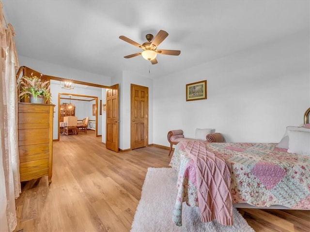 12806 33rd Hwy, Kearney, MO 64060 - bedroom with light wood-style floors, baseboards, a ceiling fan, and a chandelier