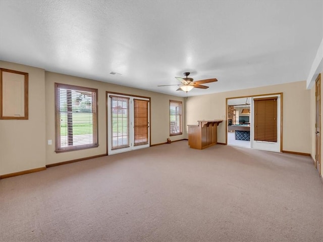 12806 33rd Hwy, Kearney, MO 64060 - unfurnished living room featuring light colored carpet, baseboards, and ceiling fan