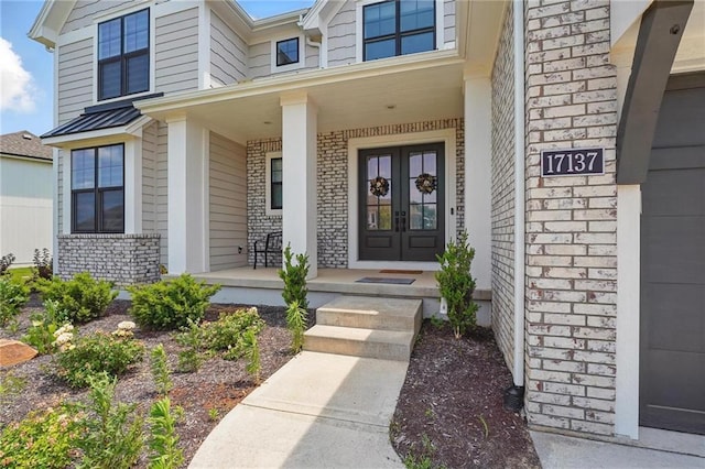 17137 Barton St, Overland Park, KS 66221 - property entrance with french doors, brick siding, and a porch