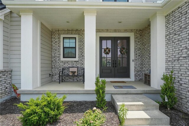17137 Barton St, Overland Park, KS 66221 - property entrance featuring covered porch and brick siding