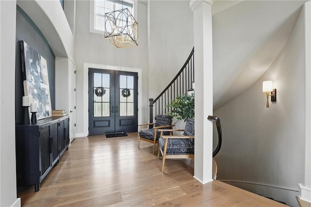 17137 Barton St, Overland Park, KS 66221 - foyer entrance featuring a high ceiling, french doors, light wood-type flooring, stairway, and baseboards