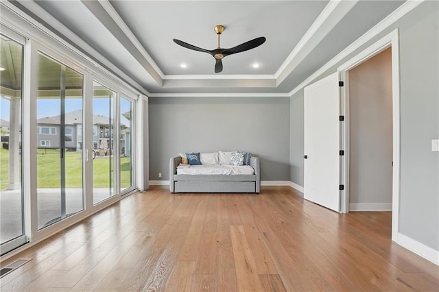 17137 Barton St, Overland Park, KS 66221 - living area with a tray ceiling, light wood-type flooring, a ceiling fan, ornamental molding, and baseboards