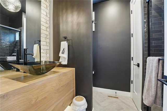 17137 Barton St, Overland Park, KS 66221 - bathroom featuring vanity, a tile shower, and baseboards