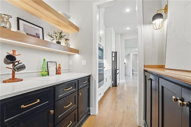 17137 Barton St, Overland Park, KS 66221 - bar area with appliances with stainless steel finishes, light wood-style floors, and recessed lighting