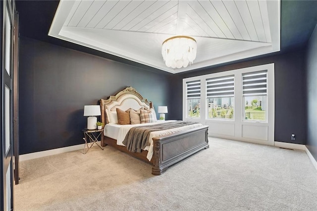 17137 Barton St, Overland Park, KS 66221 - carpeted bedroom featuring a chandelier, a tray ceiling, and baseboards
